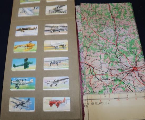 A WW II linen map, cigarette cards & a postcard album